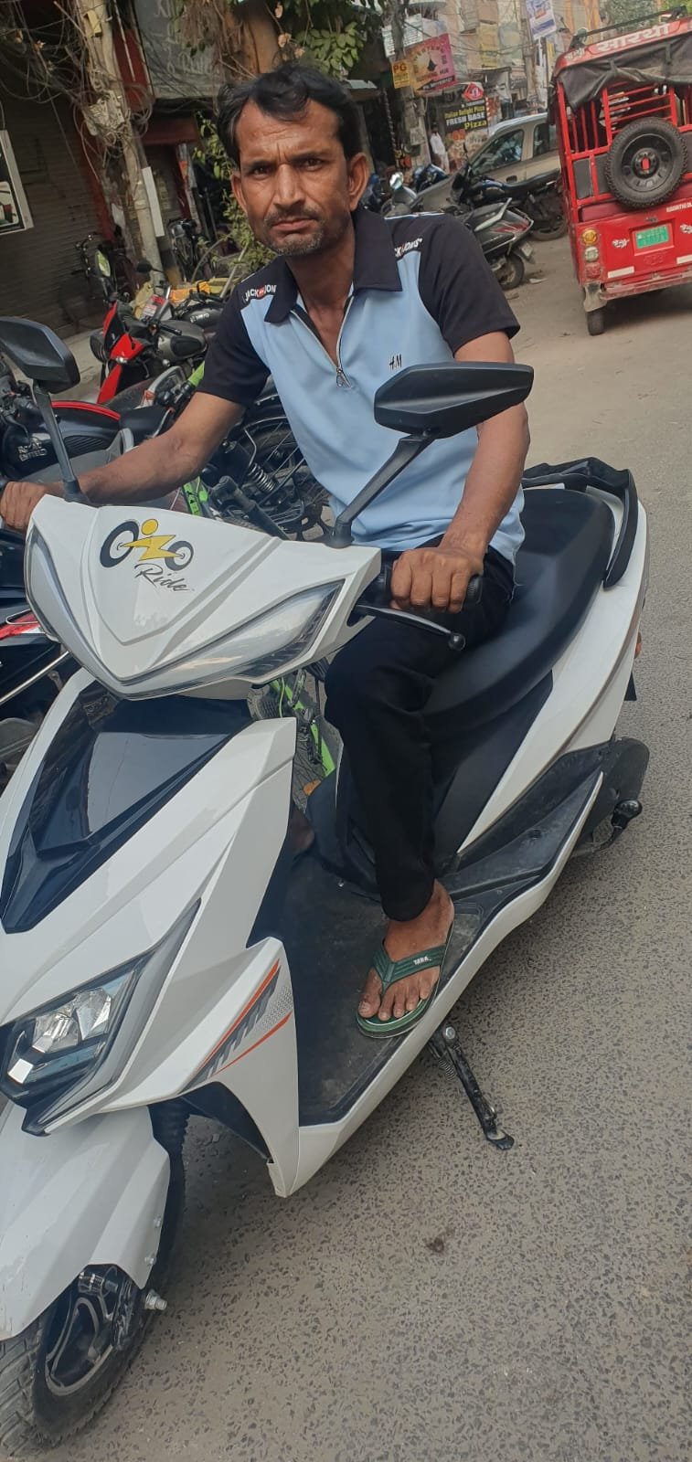 Ozoride individual rider handover with white electric scooty