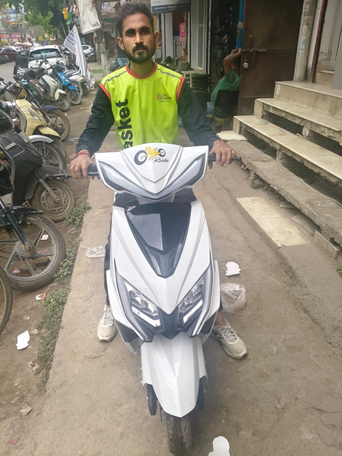 Ozoride rider with white electric scooty during onboarding