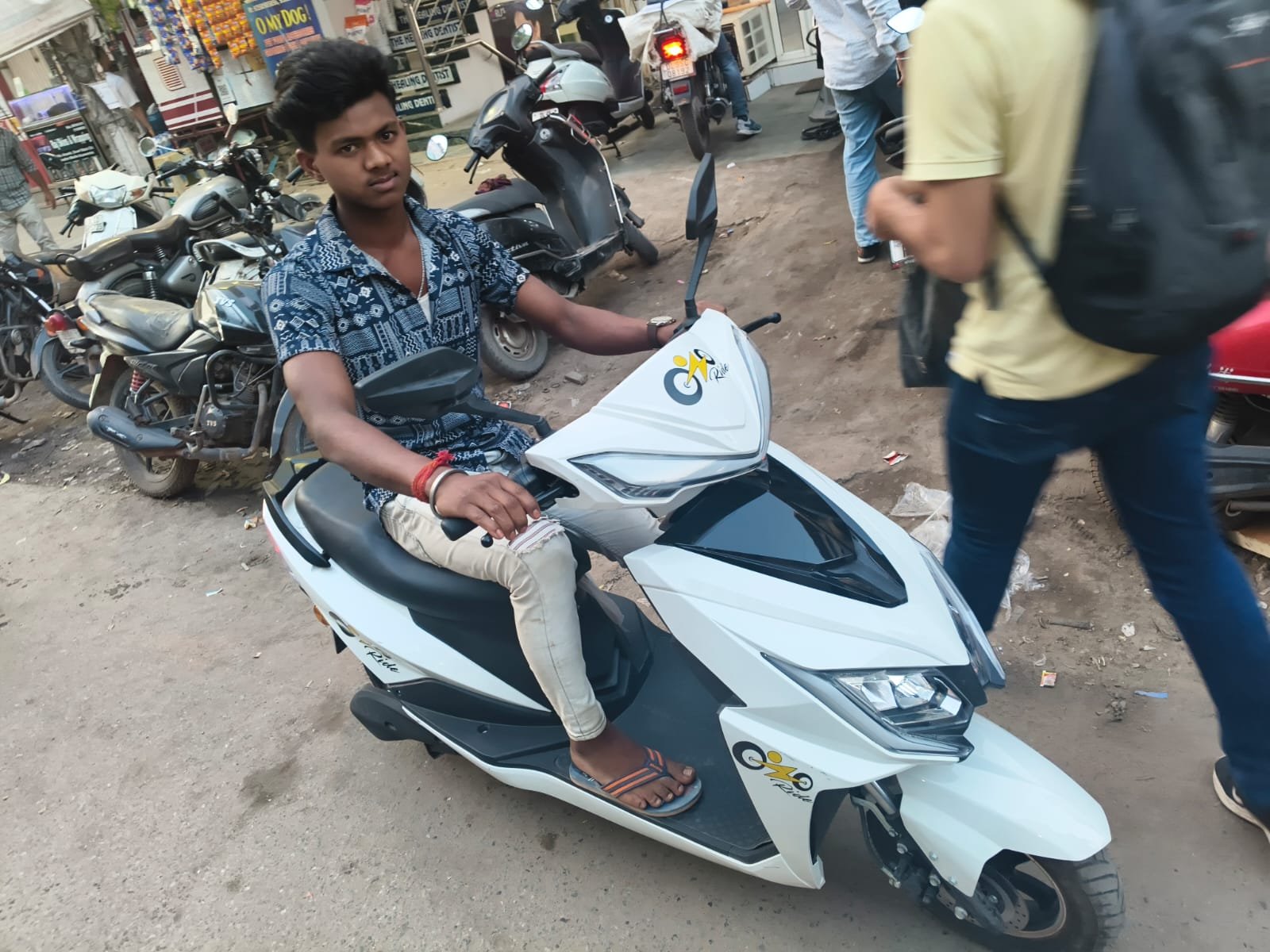 Ozoride rider onboarding with white electric scooty